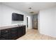 Kitchenette with black cabinets, tan countertops, stainless steel fridge, and tile flooring at 5166 Silverheart Ave, Las Vegas, NV 89142