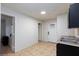 Kitchenette with tiled floors, sink, cabinets, and access to doors and entryways at 5166 Silverheart Ave, Las Vegas, NV 89142
