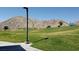 Scenic mountain view overlooking the green grass common area, a great space to stretch out and enjoy nature at 5236 Sunstone Mesa Dr, Las Vegas, NV 89166