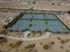 Aerial view of community tennis courts surrounded by desert landscaping at 5236 Sunstone Mesa Dr, Las Vegas, NV 89166