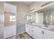 Elegant bathroom with double sinks, white cabinets, and a glass-enclosed shower at 5846 Slate Rock Ct, Las Vegas, NV 89149