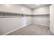 Spacious walk-in closet with ample shelving and neutral carpeting at 5846 Slate Rock Ct, Las Vegas, NV 89149
