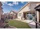 Relaxing backyard with a covered patio, swing, and manicured landscaping at 609 Viale Machiavelli Ln, Henderson, NV 89011