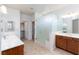 Bright bathroom with double sink vanity, glass shower, and walk-in closet at 609 Viale Machiavelli Ln, Henderson, NV 89011