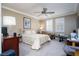 Bright and airy bedroom with plantation shutters, ceiling fan, and carpet flooring at 609 Viale Machiavelli Ln, Henderson, NV 89011