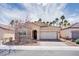 Charming single-story home featuring a stone facade, well-kept landscaping, and a two-car garage at 609 Viale Machiavelli Ln, Henderson, NV 89011