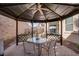 Charming gazebo with dining area, offering a delightful view of the well-manicured backyard and outdoor living space at 609 Viale Machiavelli Ln, Henderson, NV 89011