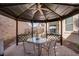Covered gazebo with an outdoor dining table, chairs, and string lights at 609 Viale Machiavelli Ln, Henderson, NV 89011