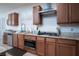 Gourmet kitchen with custom cabinets, granite counters, and stainless steel appliances at 609 Viale Machiavelli Ln, Henderson, NV 89011
