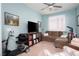 Cozy living room with plush seating, a ceiling fan, and natural light streaming through plantation shutters at 609 Viale Machiavelli Ln, Henderson, NV 89011