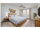 Main bedroom with ceiling fan, television, and decorative wall art at 609 Viale Machiavelli Ln, Henderson, NV 89011