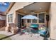Relaxing covered patio with stylish furniture, ceiling fan, and easy access to indoor living space at 609 Viale Machiavelli Ln, Henderson, NV 89011