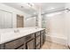 A bathroom featuring a double sink vanity with dark cabinets and a shower-tub combination at 6697 Boom Town Dr, Las Vegas, NV 89122