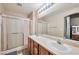 Bathroom featuring a double sink vanity and a shower with sliding glass doors at 6891 Nickel Mine Ave, Las Vegas, NV 89122