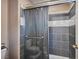 Bathroom featuring a shower, a toilet, and tile flooring and walls at 6891 Nickel Mine Ave, Las Vegas, NV 89122
