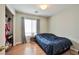 Bedroom featuring a window, wood-look floors and a closet with clothes at 6891 Nickel Mine Ave, Las Vegas, NV 89122