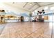 Spacious clubhouse featuring a large common area, stainless steel kitchen and cozy stone fireplace at 6891 Nickel Mine Ave, Las Vegas, NV 89122
