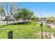 Community dog park with fenced in grass area and residential buildings in the background at 6891 Nickel Mine Ave, Las Vegas, NV 89122