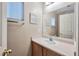 Compact half bathroom with a vanity, mirror, and window at 6891 Nickel Mine Ave, Las Vegas, NV 89122