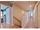 Upstairs hallway with wood-look flooring and doors leading to various rooms at 6891 Nickel Mine Ave, Las Vegas, NV 89122