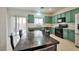 Kitchen and dining area with stainless steel appliances, and green cabinets at 6891 Nickel Mine Ave, Las Vegas, NV 89122