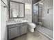 Modern bathroom featuring a stylish vanity, a toilet, and a glass-enclosed shower with gray tiles at 7110 Brighton Village St, Las Vegas, NV 89166