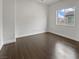 Bright bedroom featuring hardwood floors, white walls and trim, and a window providing natural light at 7110 Brighton Village St, Las Vegas, NV 89166