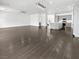 Open-concept living area features dark wood floors, a ceiling fan, and recessed lighting at 7110 Brighton Village St, Las Vegas, NV 89166