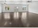 Bright living room featuring hardwood floors, recessed lighting, and double doors with access to the pool at 7110 Brighton Village St, Las Vegas, NV 89166