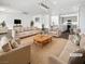 Spacious living room features contemporary furnishings, a ceiling fan, and an open-concept kitchen view at 7110 Brighton Village St, Las Vegas, NV 89166