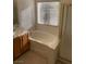 Bathroom with a tub, shower, and neutral cabinets at 7456 Oatman Ln, Las Vegas, NV 89120