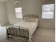 Comfortable bedroom with neutral carpet and light walls with a queen-size bed at 7456 Oatman Ln, Las Vegas, NV 89120