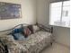 Daybed with a metal frame and a window with light-filtering blinds at 7456 Oatman Ln, Las Vegas, NV 89120