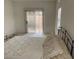 Bright bedroom with a slider and a bed with a decorative quilt and pillows at 7456 Oatman Ln, Las Vegas, NV 89120