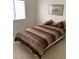 Bedroom with neutral carpet, light walls, and a queen-size bed at 7456 Oatman Ln, Las Vegas, NV 89120