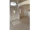 Bright and airy living room featuring neutral carpet, white walls, and transom windows at 7456 Oatman Ln, Las Vegas, NV 89120