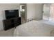 Bedroom with a TV, closet, and sliding door accessing outside at 7456 Oatman Ln, Las Vegas, NV 89120