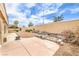 Landscaped backyard with desert landscaping, rock features, and a spacious patio area, perfect for outdoor living at 7613 Falconwing Ave, Las Vegas, NV 89131