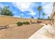 Private backyard features low-maintenance gravel, rock accents, and desert plants behind a stucco wall at 7613 Falconwing Ave, Las Vegas, NV 89131