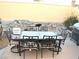 Outdoor dining area with a built-in water feature, barbecue, and gravel for relaxed entertaining at 7613 Falconwing Ave, Las Vegas, NV 89131