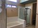 Bright bathroom with a bathtub, glass shower, and a unique stained glass window for added charm at 7613 Falconwing Ave, Las Vegas, NV 89131