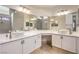 Bright bathroom featuring dual vanity sinks, with tile floors and modern fixtures at 7613 Falconwing Ave, Las Vegas, NV 89131