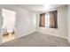 Cozy bedroom with carpet, window, and ensuite bathroom with toilet and sink at 7613 Falconwing Ave, Las Vegas, NV 89131