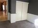 Bedroom with gray walls, white wainscoting, and sliding closet doors, offering ample storage space at 7613 Falconwing Ave, Las Vegas, NV 89131