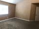 Cozy bedroom with neutral walls, plush carpet, and bright natural light from the window at 7613 Falconwing Ave, Las Vegas, NV 89131