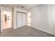 Bedroom with plush carpet and views to a guest bathroom and front living area at 7613 Falconwing Ave, Las Vegas, NV 89131