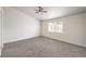 Spacious bedroom featuring neutral carpet, ceiling fan, and a large window with natural light at 7613 Falconwing Ave, Las Vegas, NV 89131