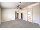 Large bedroom with high ceiling, neutral carpet, and ensuite bathroom at 7613 Falconwing Ave, Las Vegas, NV 89131