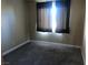 Bright bedroom with neutral walls, soft carpet, and a window with curtains, creating a serene atmosphere at 7613 Falconwing Ave, Las Vegas, NV 89131