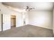 Bright bedroom featuring a ceiling fan, neutral carpet, and access to the ensuite bath and walk-in closet at 7613 Falconwing Ave, Las Vegas, NV 89131